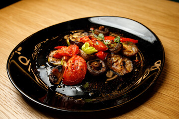 grilled vegetables on a black plate