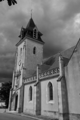 Church tower under an overcast sky, black and white photo