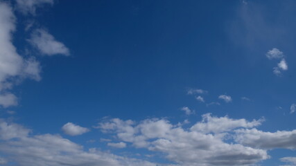 Obraz premium Frame of Beautiful blue sky with clouds background. Sky clouds. Air and fluffy clouds in the blue sky on a sunny day, background texture. Copy space. The concept of hope.