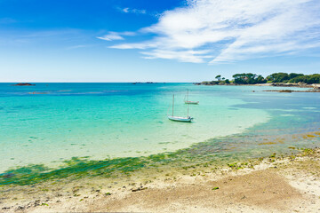 Two white fishing boats in bay near Le Hocq Tower on the south shore of Jersey, Channel Islands, Britain, on a sunny summer day.