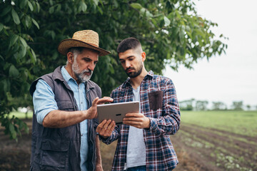 farmers using digital tablet outdoors