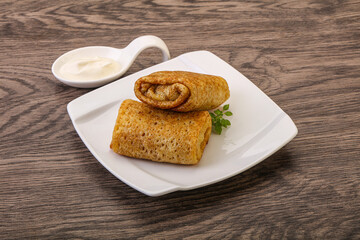 Staffed pancakes served sour cream