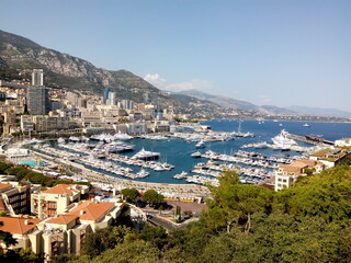 Fototapeta na wymiar Panoramic view of the city in Monaco country on a sunny summer day. Wonderful journey to Azure Coast in French Riviera.