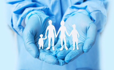 Family care and protect concept. adult and children cut out paper silhouette on hands doctor.
