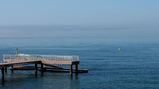 View of mediterranean sea from the dock of Punta Doncella beach (maiden tip) in Estepona, Costa del sol, Spain