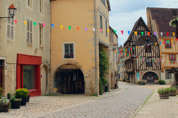 Streetview of a charming narrow street of an antique French town of Noyers sur Serein in Burgundy, one of the most beautiful villages of France with lots of historic architecture and cultural heritage