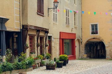 Fototapeta na wymiar Streetview of a charming narrow street of an antique French town of Noyers sur Serein in Burgundy, one of the most beautiful villages of France with lots of historic architecture and cultural heritage
