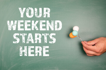 Your weekend starts here. Miniature balloons in a man's hands on a green chalk board