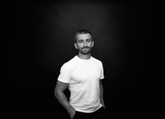 Fototapeta premium handsome and smiling guy on a black background