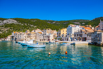 Seafront view at coastal town Komiza on Island Vis, summer travel resort in Croatia, Mediterranean.