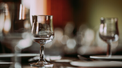 Close-up of an empty wine glass on the dining table.