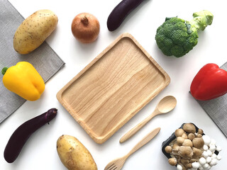 vegetables and wooden plate on table