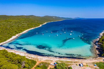 Amazing Adriatic sea in Croatia. Aerial view of azure turquoise lagoon on Sakarun beach on Dugi Otok island, yachts anchored blue sea, tourist paradise. © Mislav
