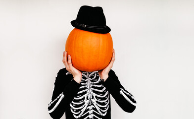 A man in a skeleton costume with a pumpkin instead of a head. Halloween Costume. Pumpkin Jack