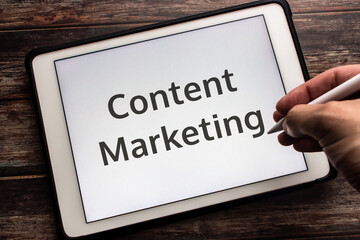 Conceptual closeup keyword Content Marketing on tablet. It is a way of marketing that focused on...