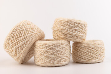 Obraz premium balls of light woolen thread on white background. natural wool. knitting. background