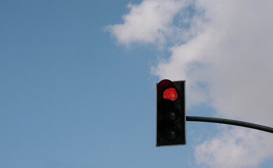 traffic light in front of cloudy sky background