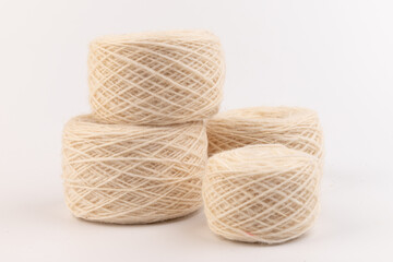 balls of light woolen thread on white background. natural wool. knitting. background