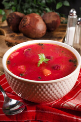 Red borscht soup in bowl.