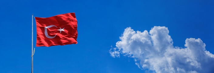 Turkish flag on cloudy sky background