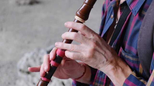 Musician playing the flute close up