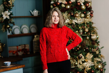 Beautiful young woman celebrating christmas at home, having fun while opening presents