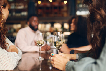 Friends relaxing with wine in bar