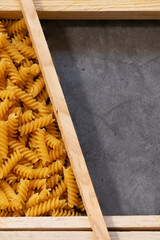 Raw pasta in asymmetrical boxes, space for text