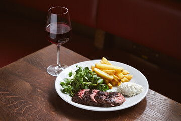 Red wine and steak in restaurant