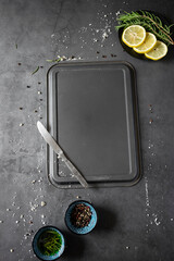 Dark food background with empty  tray and spices