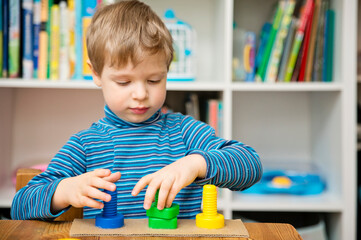 Shapes, colors and fine motor skills. toddler turns the nut on the bolt. Task to twist correct...