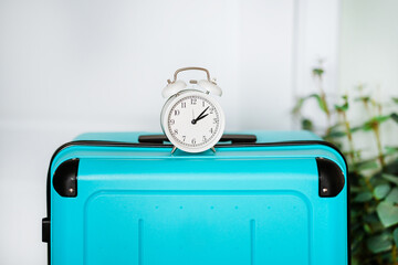 The alarm clock is on the suitcase. The concept of time to travel