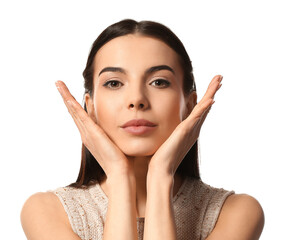 Young woman doing face building exercise against white background