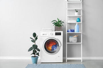 Interior of bathroom with modern washing machine