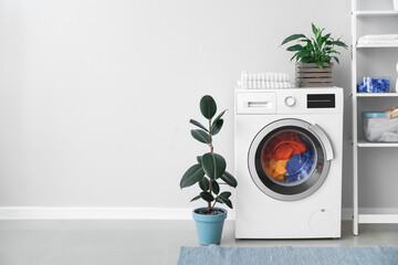 Interior of bathroom with modern washing machine