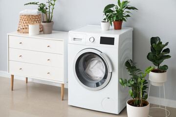 Interior of bathroom with modern washing machine