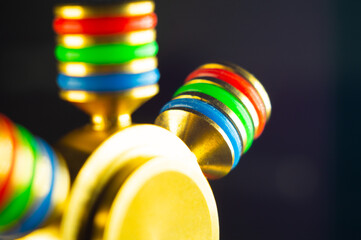 Closeup shot of details on a gold and rainbow fidget spinner