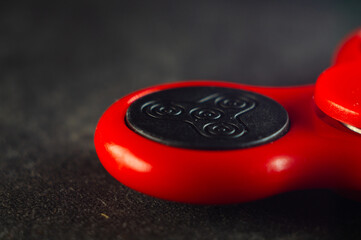 Closeup shot of details on a red fidget spinner