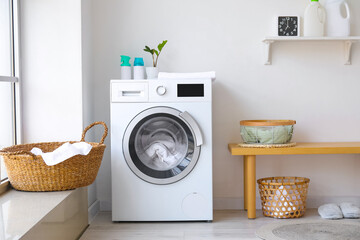 Interior of bathroom with modern washing machine