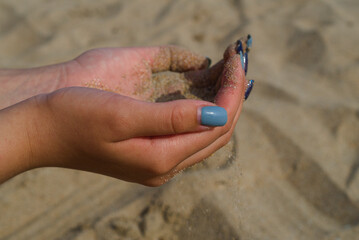 Hands and sand. Playing with sand on the beach