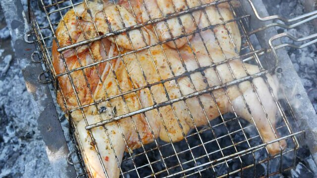 Whole juicy with spices grilled chicken tabaka or tapaka at summer picnic