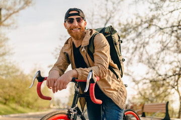 Fototapeta premium handsome bearded man traveling with bicycle in morning