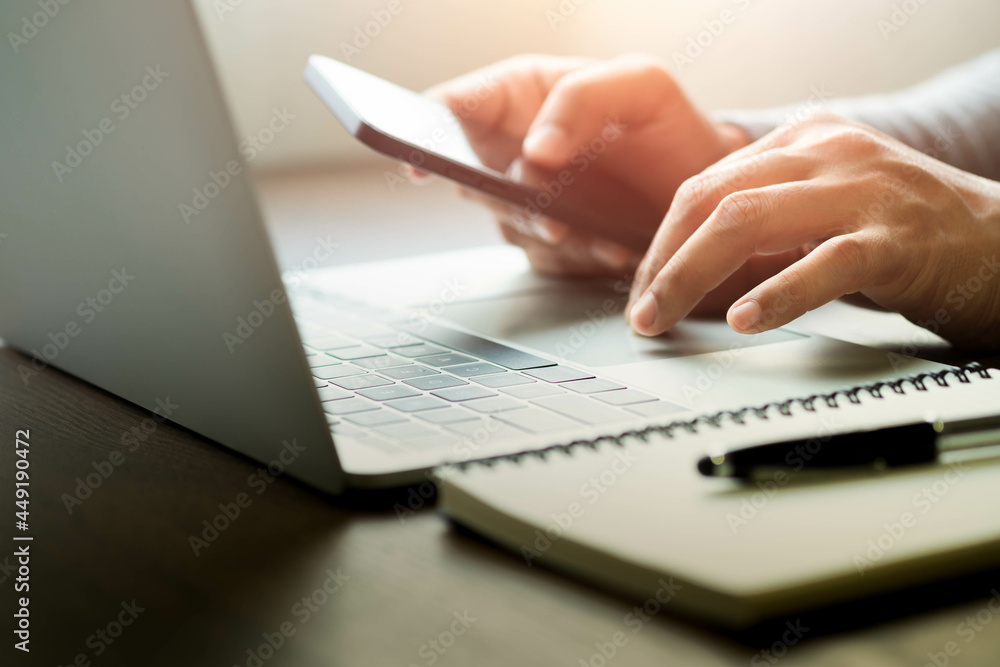 Poster close-up of man hand using and typing keyboard of laptop computer on office desk. workspace, busines