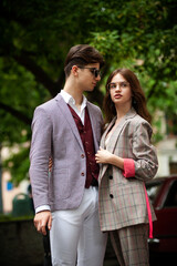 Fototapeta premium Young fashion man and stylish young woman in a formal suit outdoor in the city