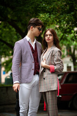 Fototapeta premium Young fashion man and stylish young woman in a formal suit outdoor in the city