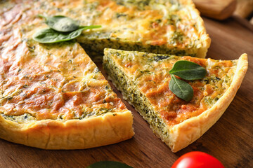 Tasty spinach tart on wooden background, closeup