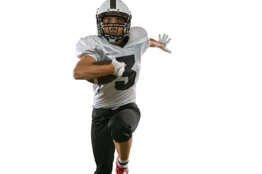 Close-up portrait of American football player in sports equipment, helmet and gloves isolated on white studio background. Concept of sport, competition
