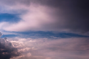 Naklejka na ściany i meble Dramatic blue sky with white and grey clouds