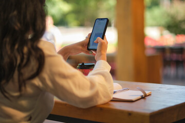 Cheerful elegant elderly woman smiling. Head shot close up portrait happy healthy middle aged woman sitting in a cafe, and is waiting for a friend