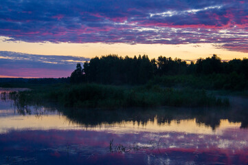 Obraz na płótnie Canvas Beautiful calm purple landscape at the sunset of the lake